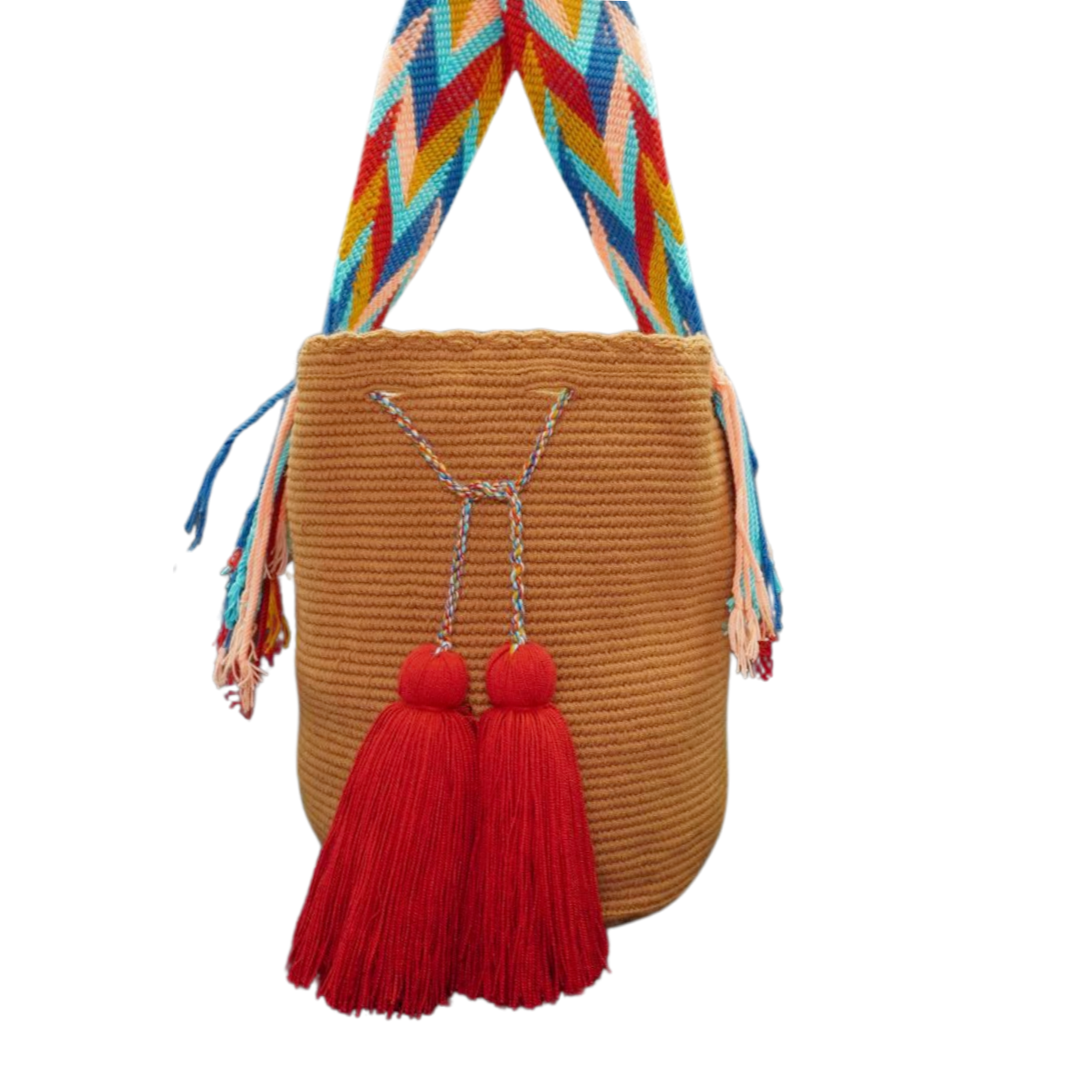 Handmade Caramel Handbag with Patterned Handel. this crochet bag has 2 deep red tassels 