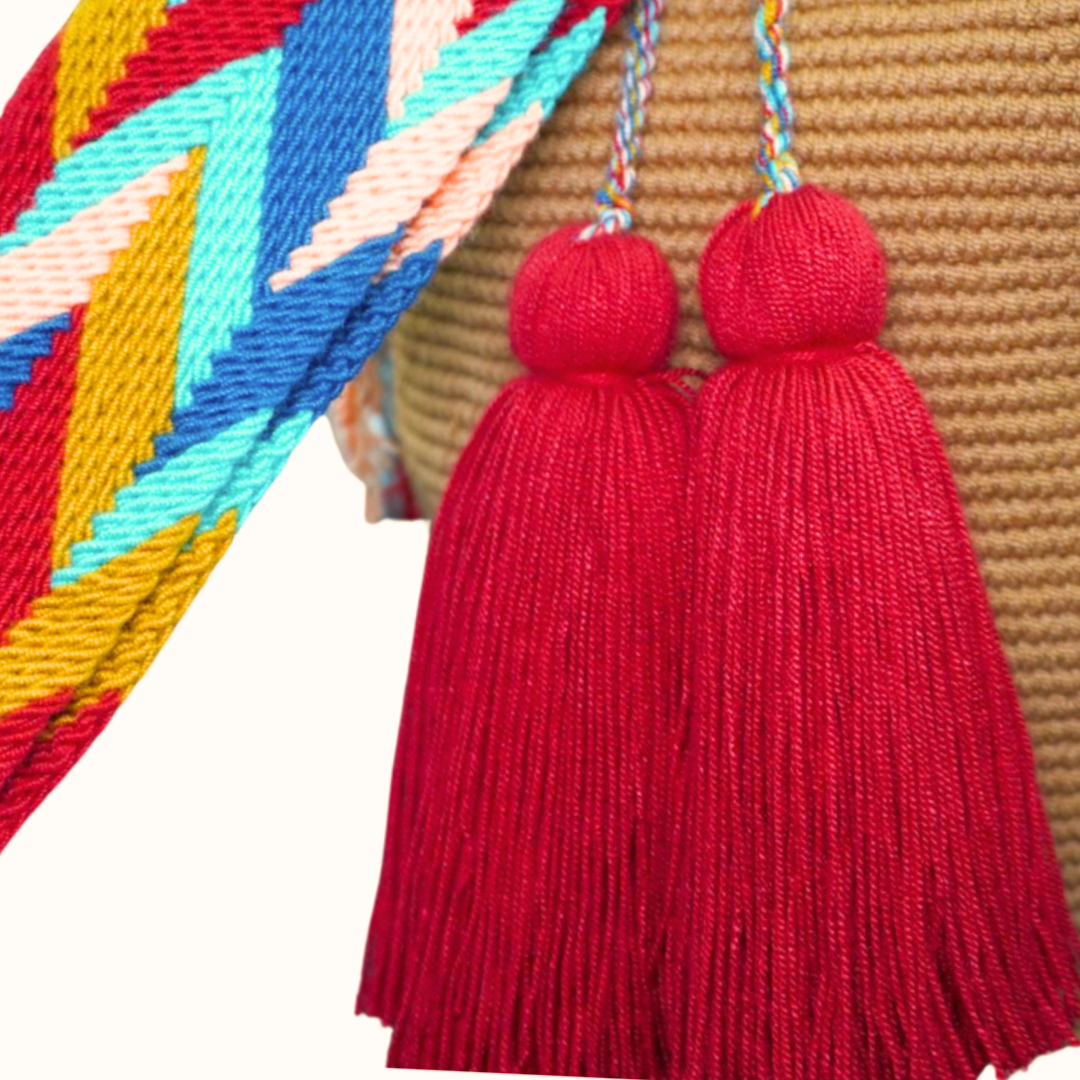 Handmade Caramel Handbag with Patterned Handel. this crochet bag has 2 deep red tassels 