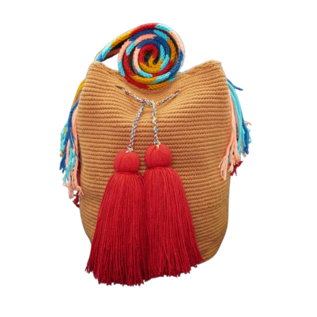 Handmade Caramel Handbag with Patterned Handel. this crochet bag has 2 deep red tassels 